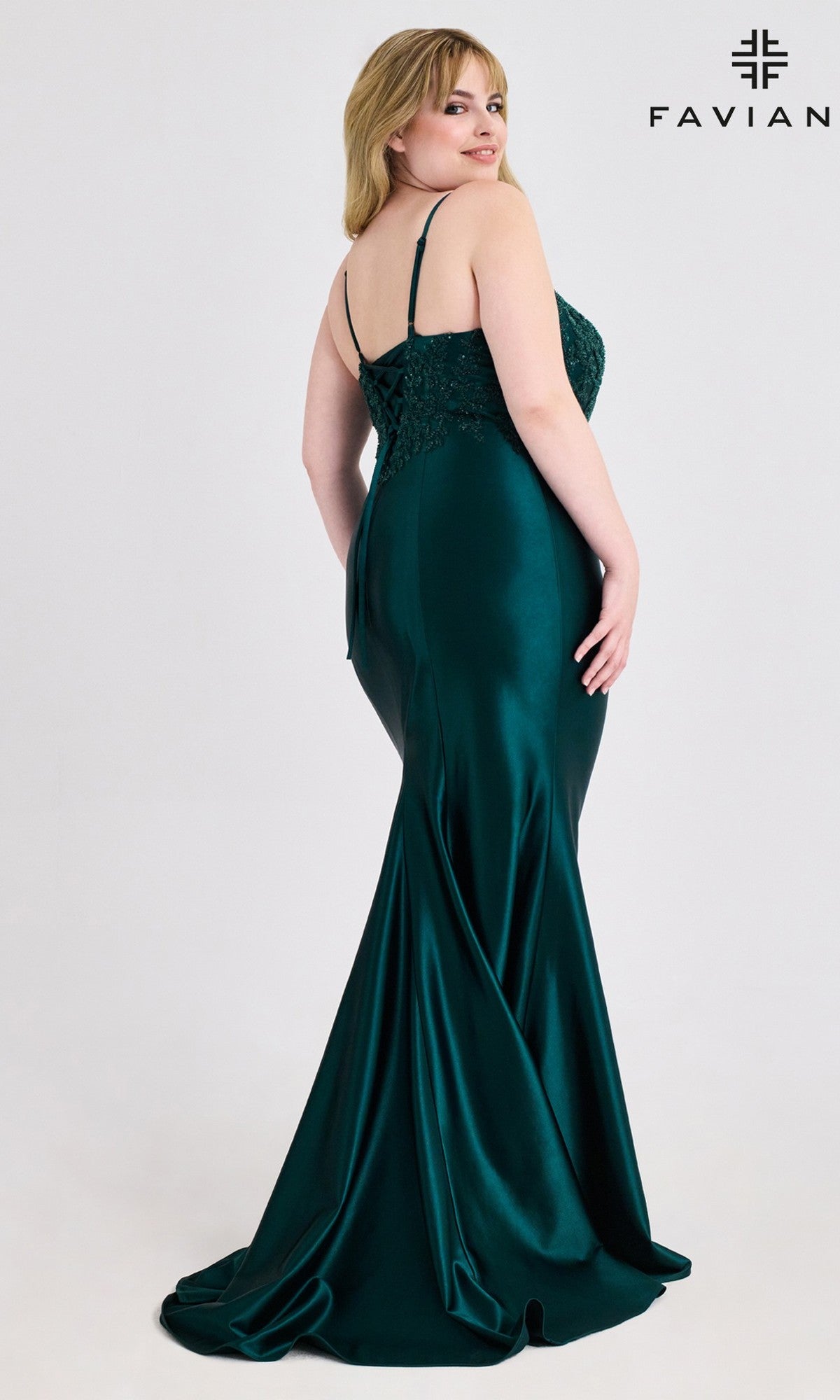 A woman in a sleeveless, floor-length dark green Plus-Size Beaded-Corset Prom Gown (Faviana 9597) poses against a light background with the Faviana logo in the top right corner.